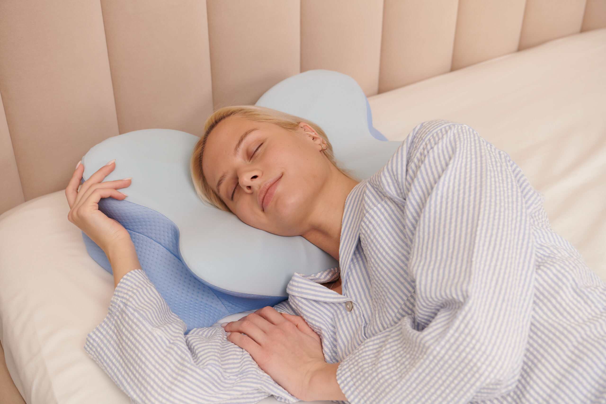 Supportive pillow styled on a cozy bed in a small bedroom