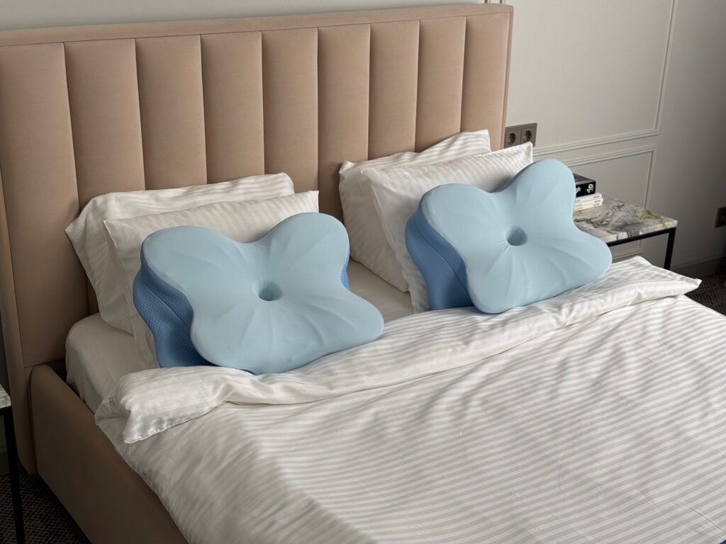 Ergonomic pillow on neutral bedding