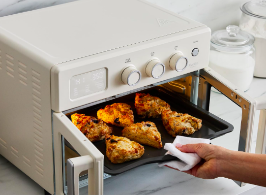 Tray of cooked chicken being removed from the Martha Stewart air fryer oven