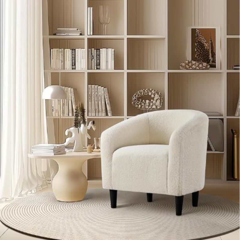 Cream boucle chair styled as a cozy reading nook
