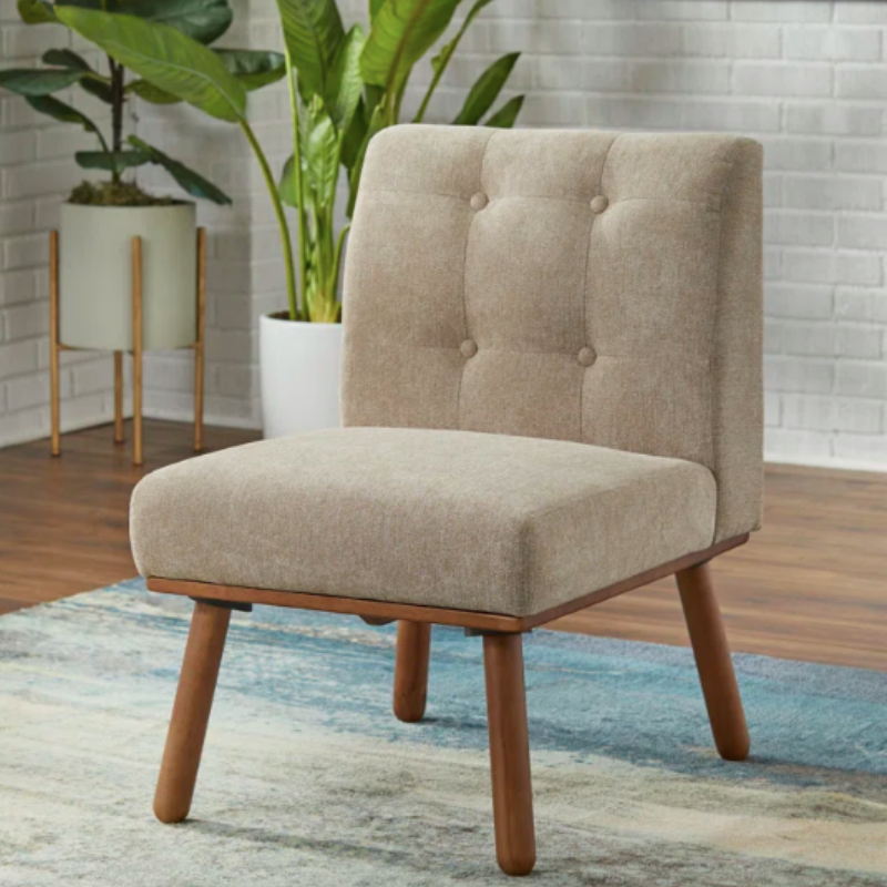Small tufted slipper chair used in a reading nook