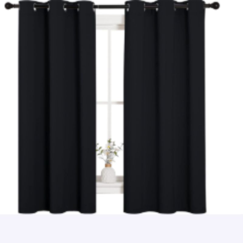 Heat-blocking curtains covering a sunny apartment window