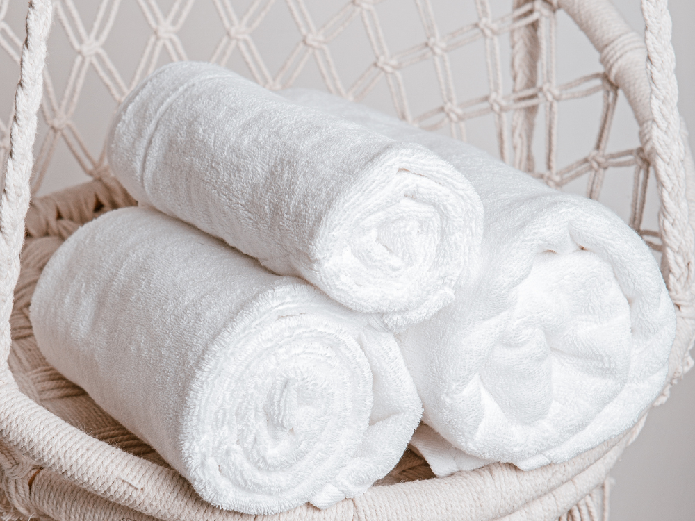 Soft towels and neutral bath mat for a cozy bathroom.